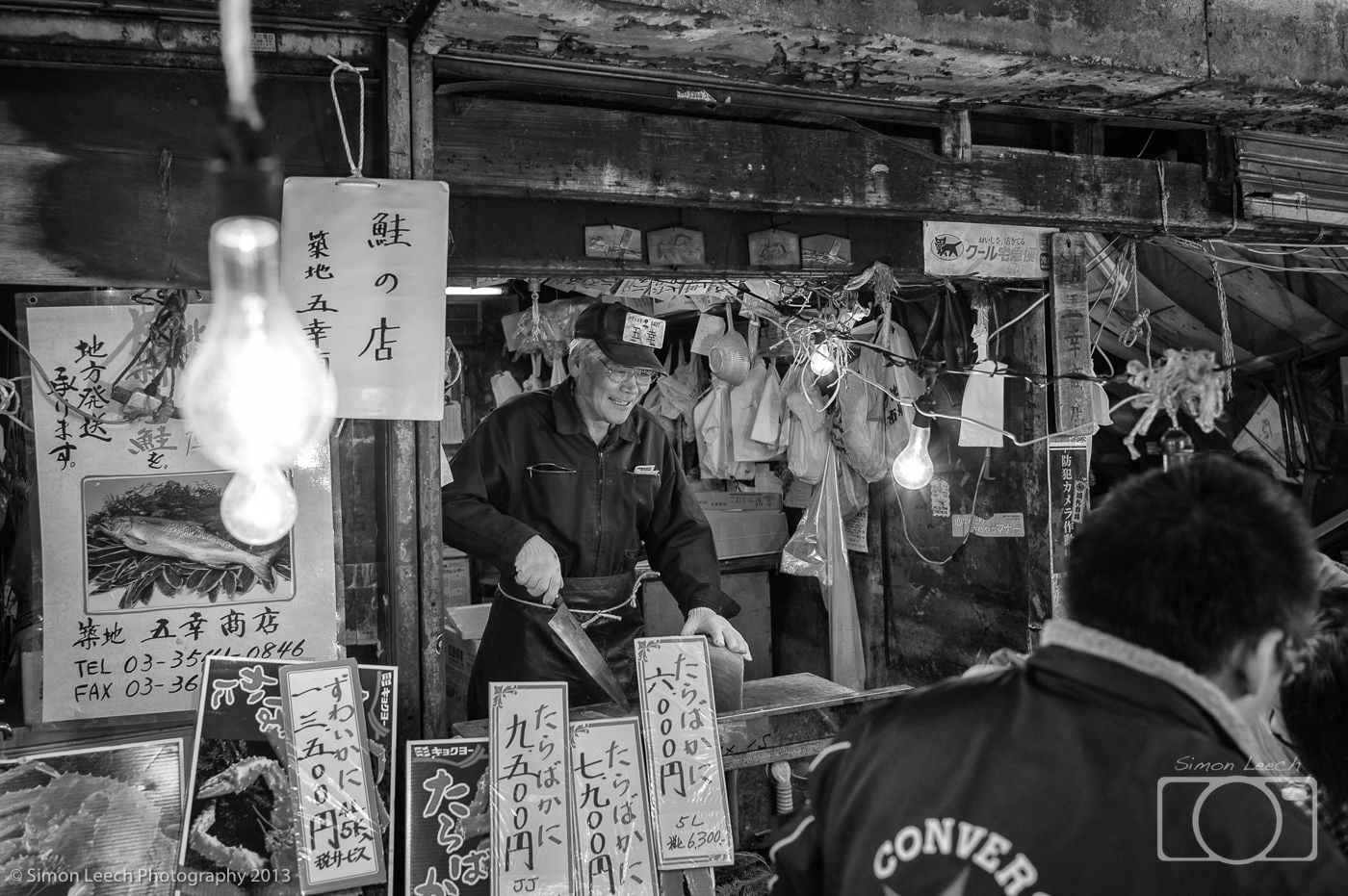 Tsukiji Market Trader preparing freshly caught fish for sale